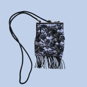 Vintage Lancôme beaded evening bag with a braided strap, a kisslock clasp